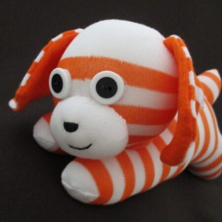 handmade orange and white sock puppy with floppy ears called Gemini